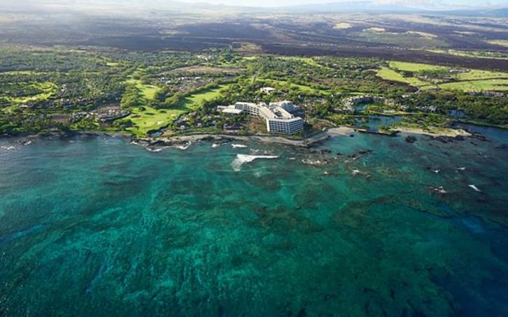 Aerial view of a large resort hotel along the Kona Coast, which is protected by huge coral reefs.