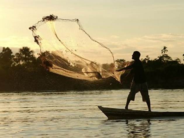 Fisherman casting his net on the Amazon River in Brazil. 